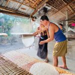 Tourist make rice noodle with local