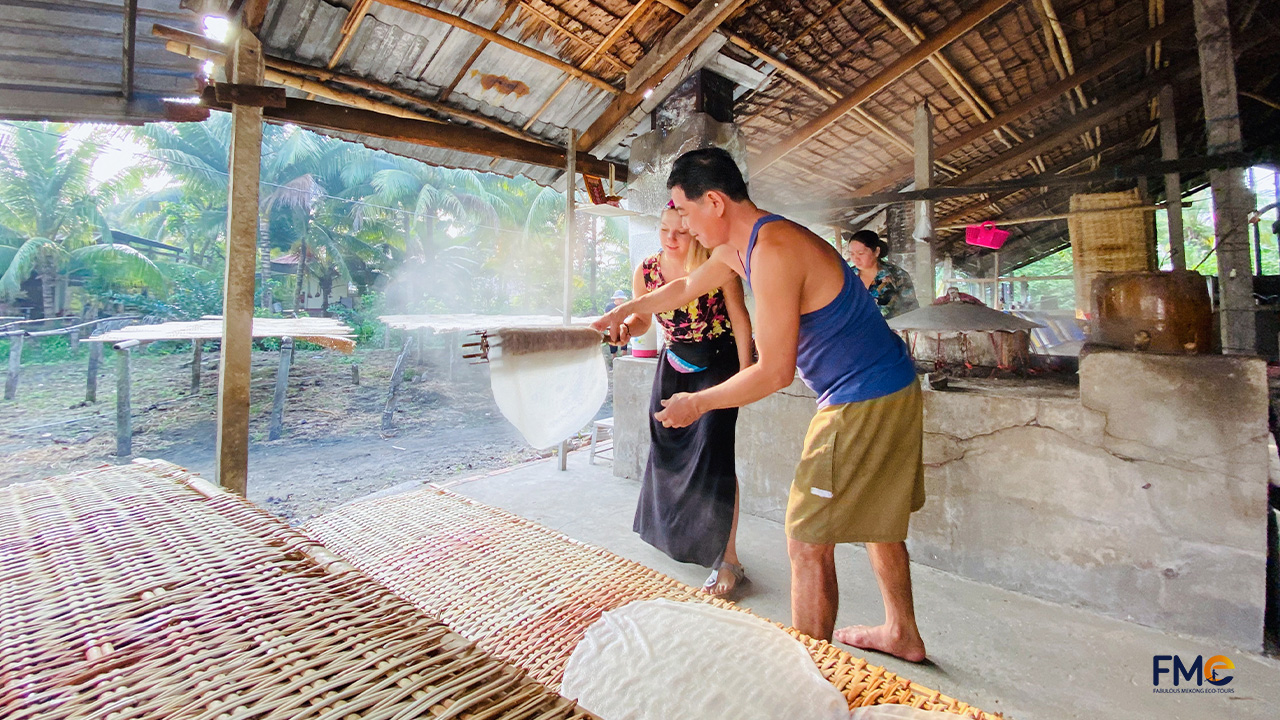 Tourist make rice noodle with local