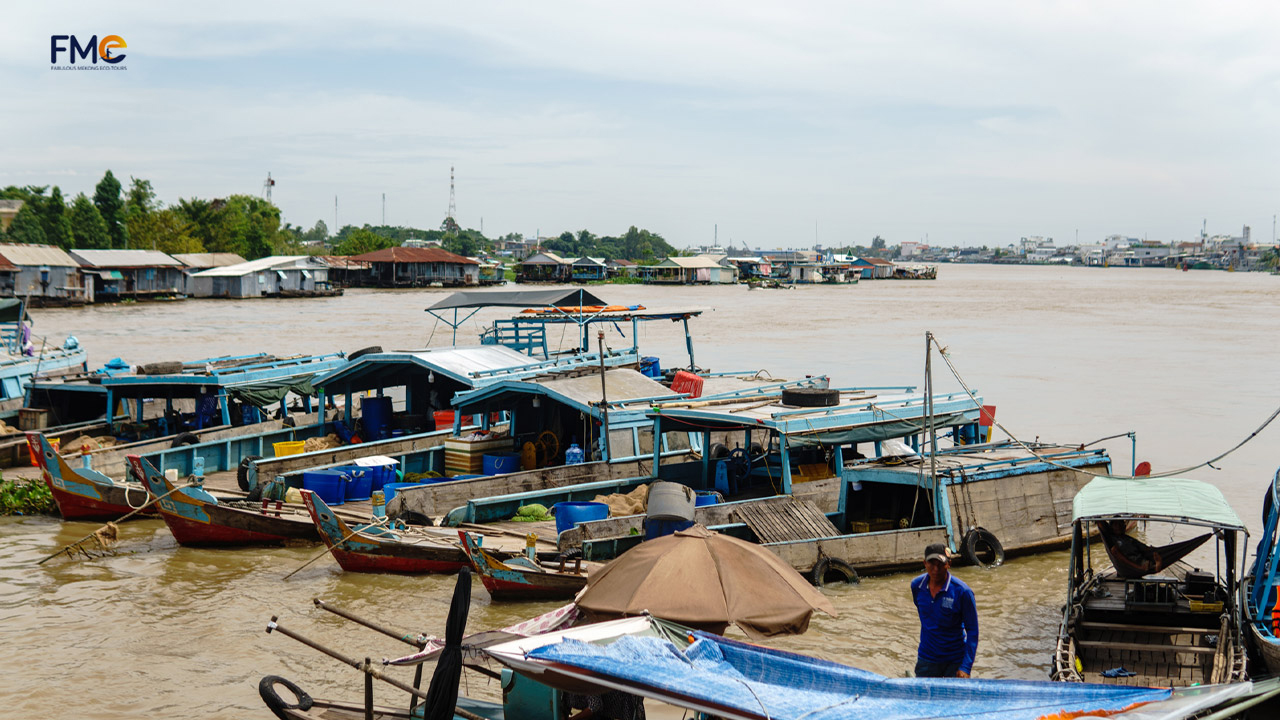 A lot of boats are docking in the middle of the floating fish farm