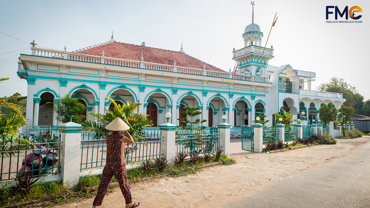 A woman is walking by the mosque