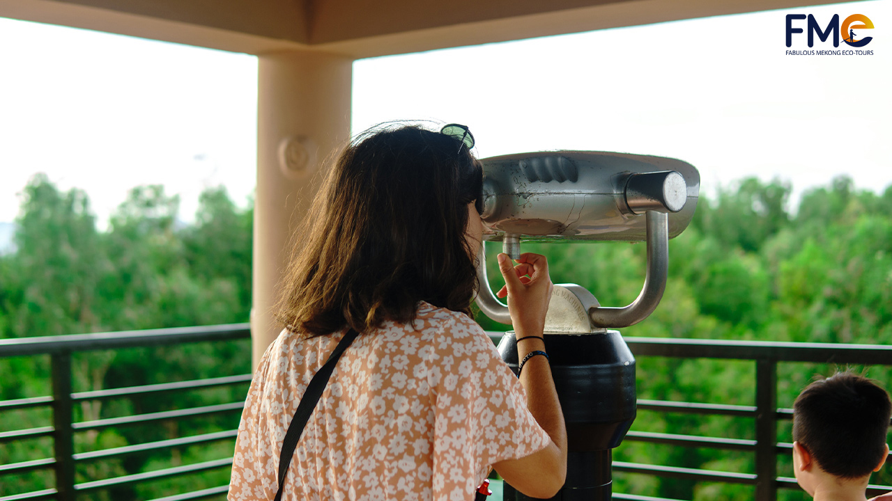 A woman looking at a telescope in the observing tower