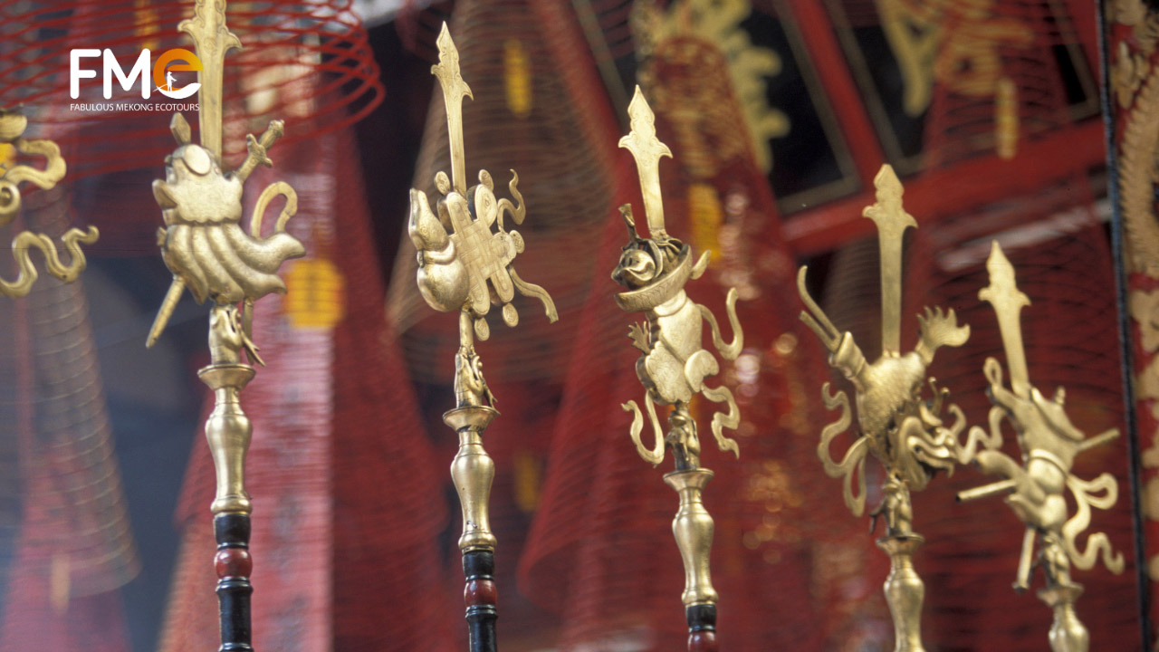 Close-up to Chinese styled weapons on a rack in Ong temple Can Tho