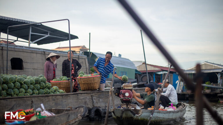 Local vendors selling watermelon at the floating market