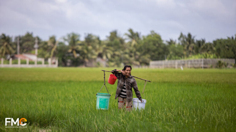 The smiling farmer carried her basket to the fields to catch fish