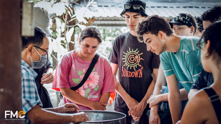 Tourists learning about the cocoa process at the farm