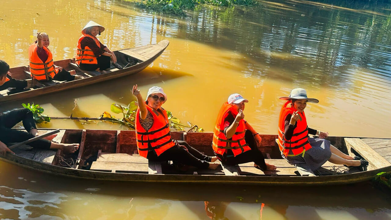 Tourists ride a traditional Vietnamese dinghy