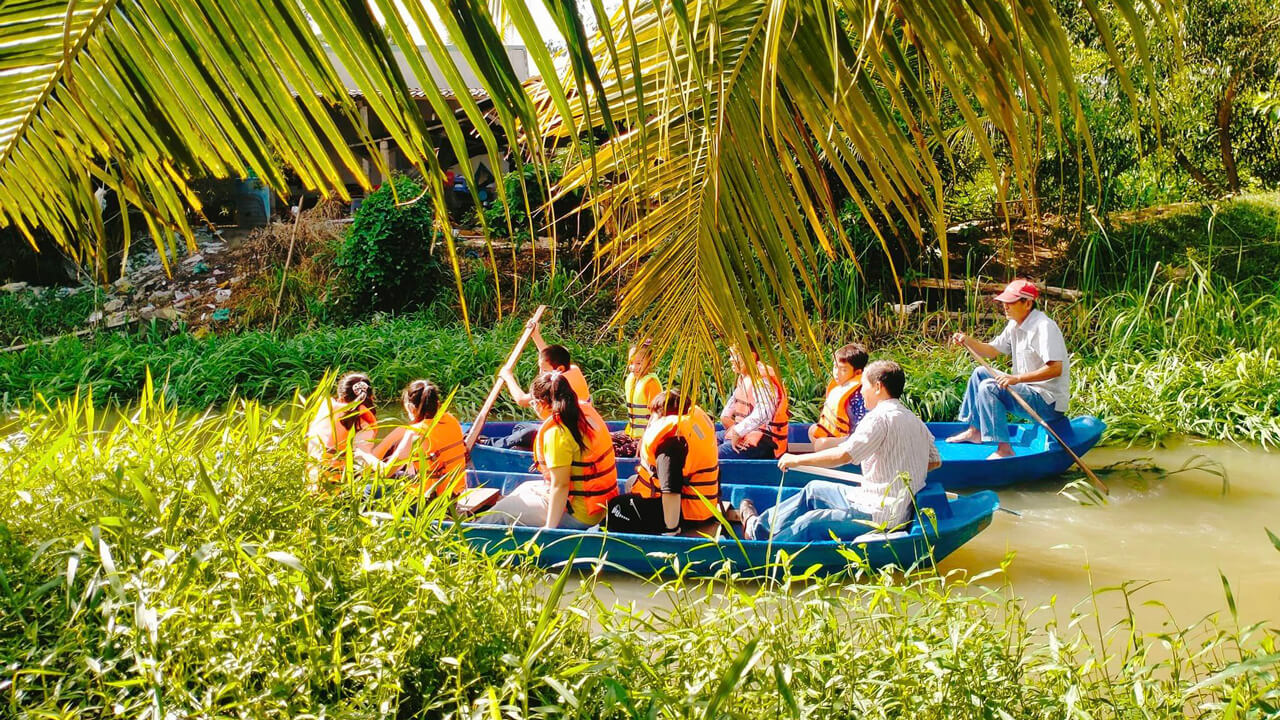 Tourists take a boat trip to Dong Nghi Dairy Goat Farm in Tien Giang