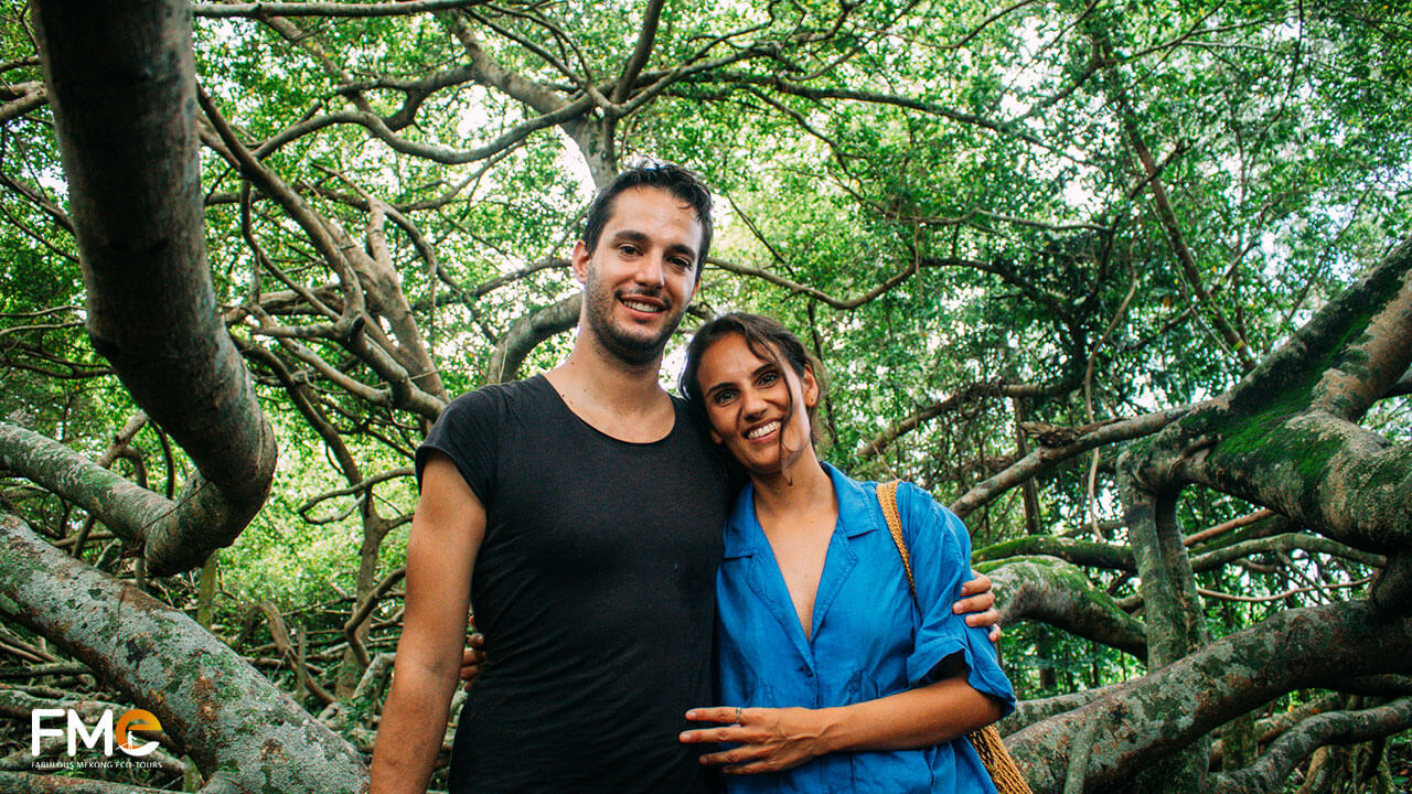 Tourists taking pictures with the ficus tree