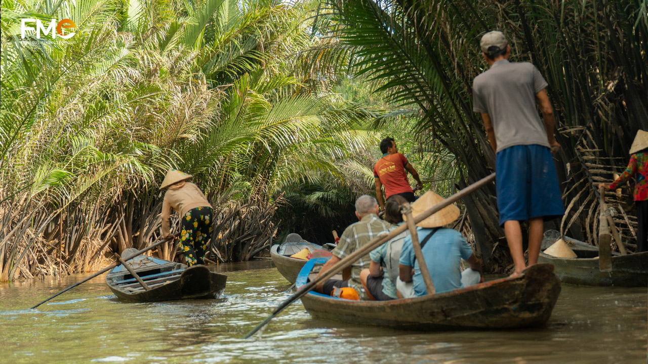 Tourists move along small canals at the tourist area in Ben Tre