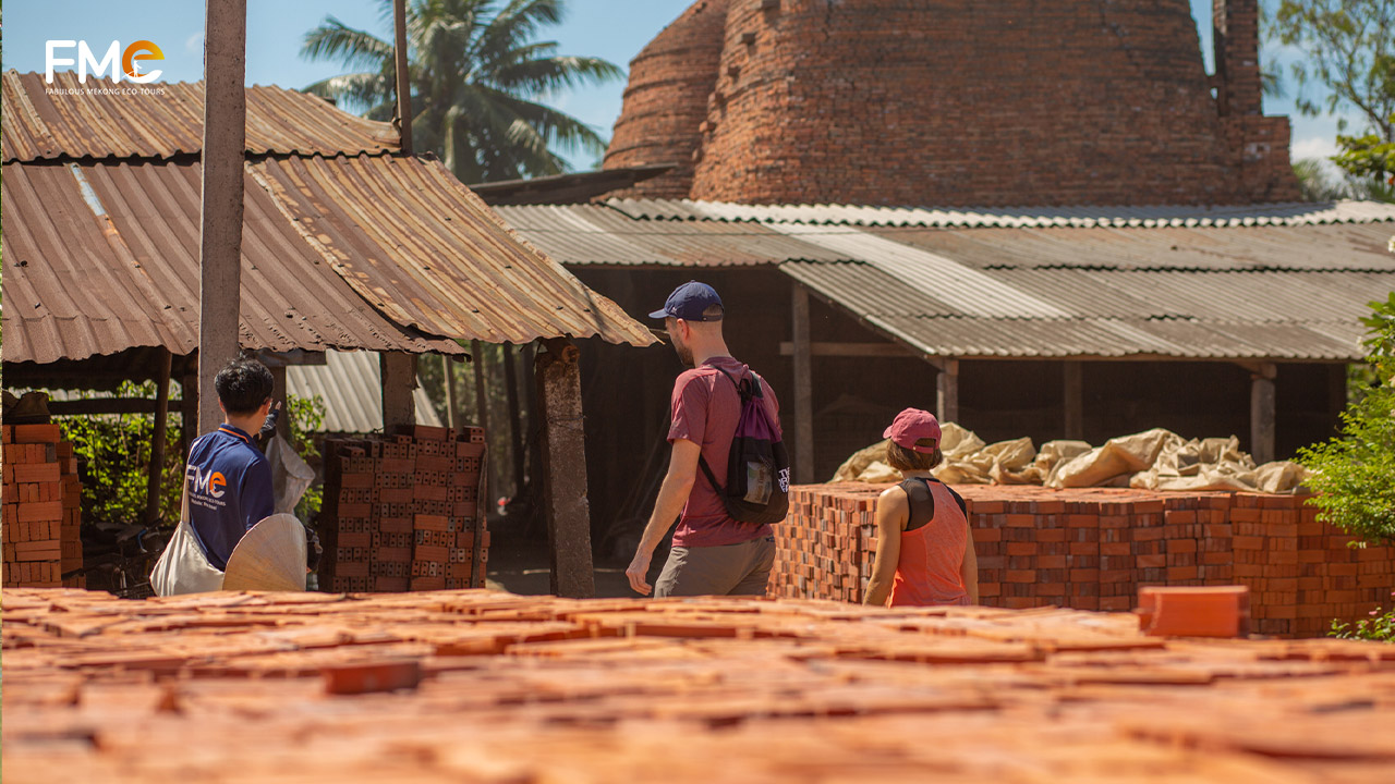 Visitors visit a traditional brick factory in a craft village in Ben Tre