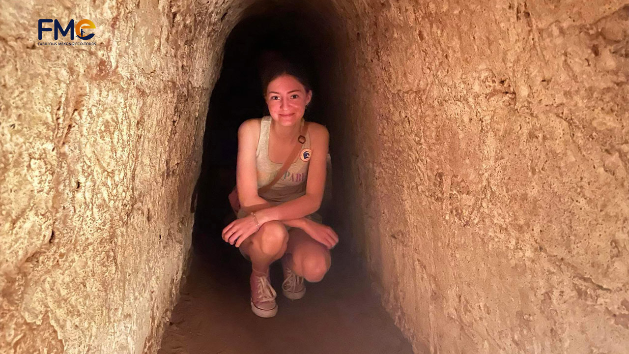 A female tourist in the bunker of Cu Chi Tunnels