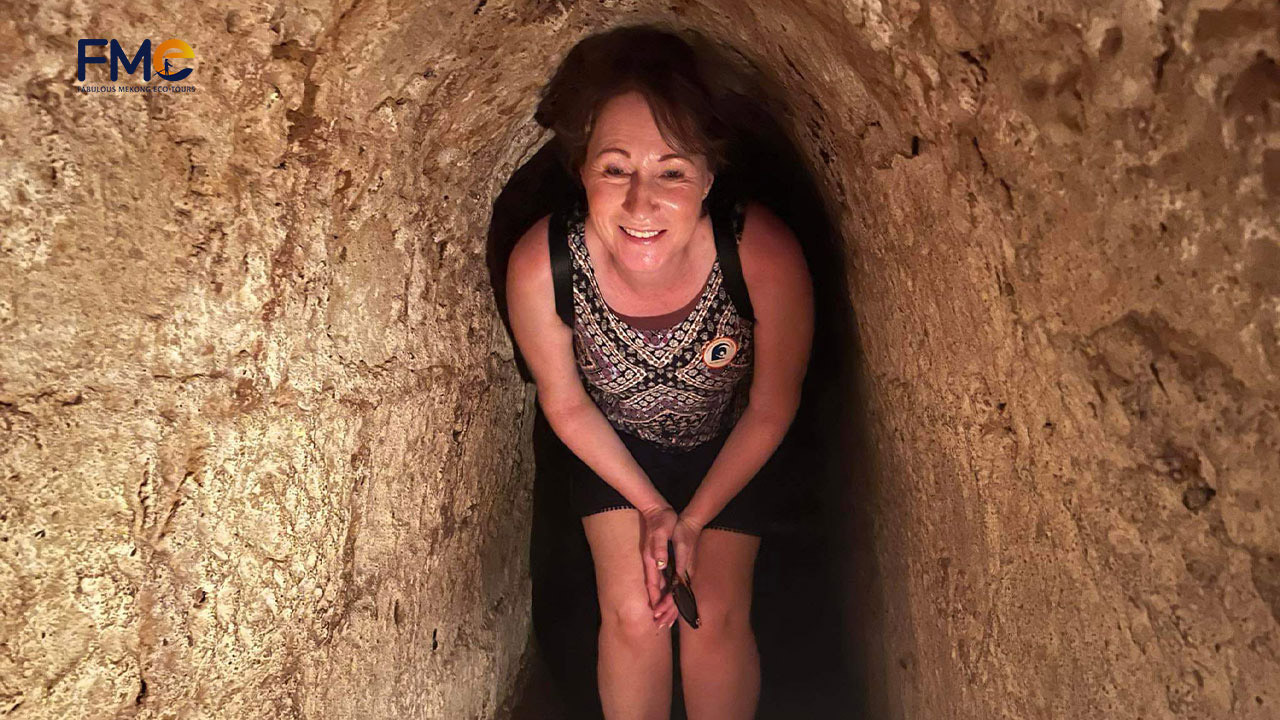 A tourist explores the bunker of Cu Chi Tunnels