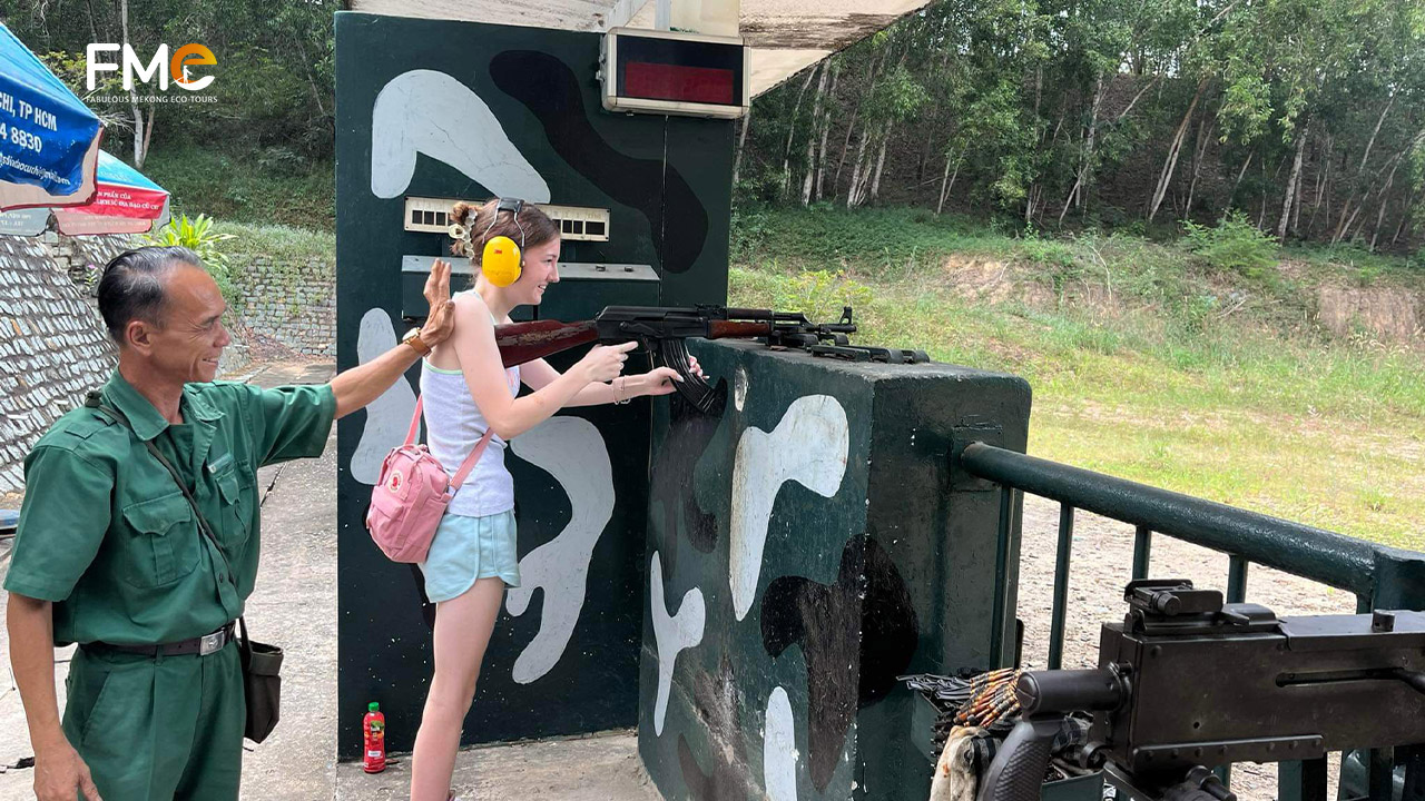 A tourist tries to shoot in the Cu Chi shooting range