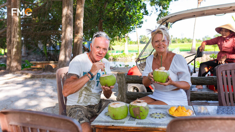 Tourists try coconut drink in Lung Ngoc Hoang