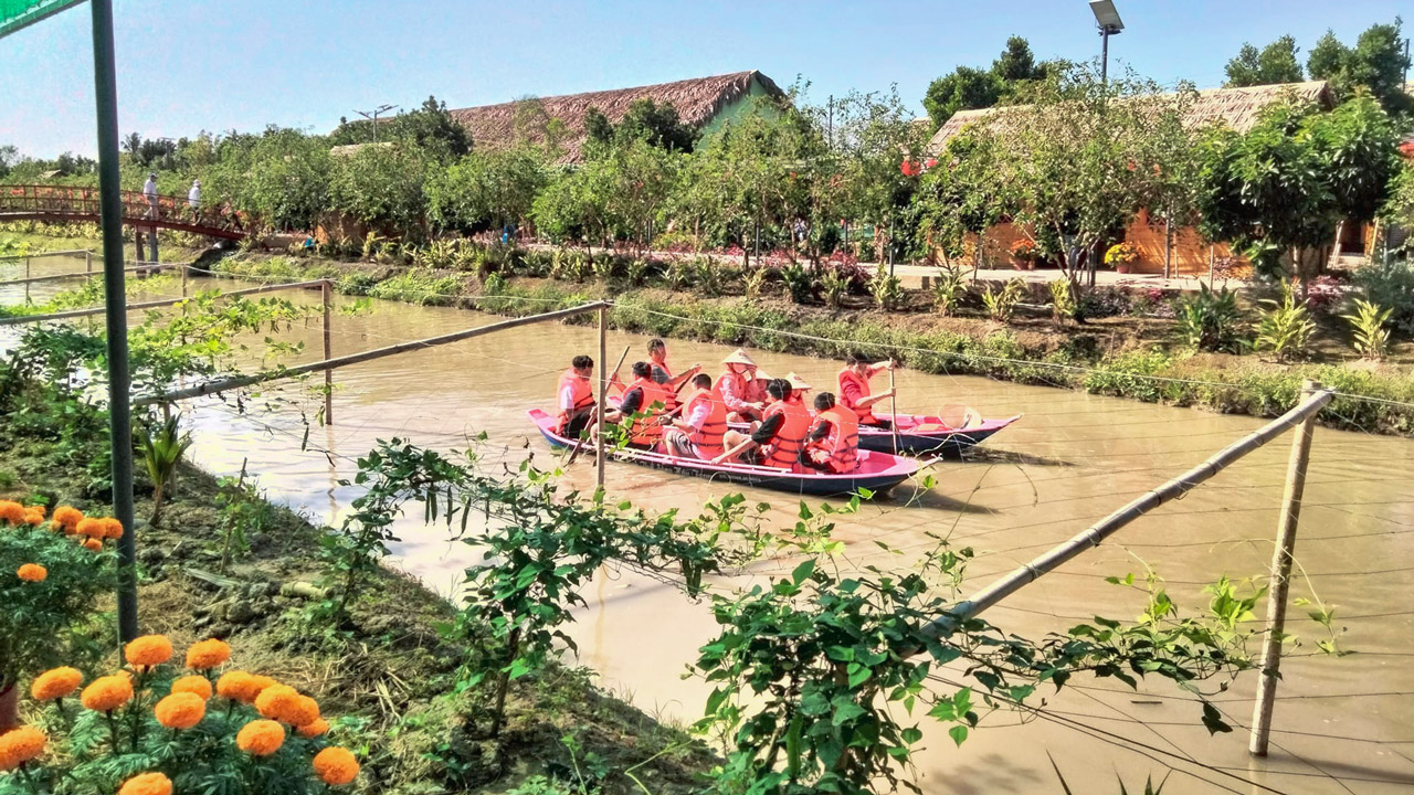 Tourists experience boating at Hau River Tourist Area in Can Tho