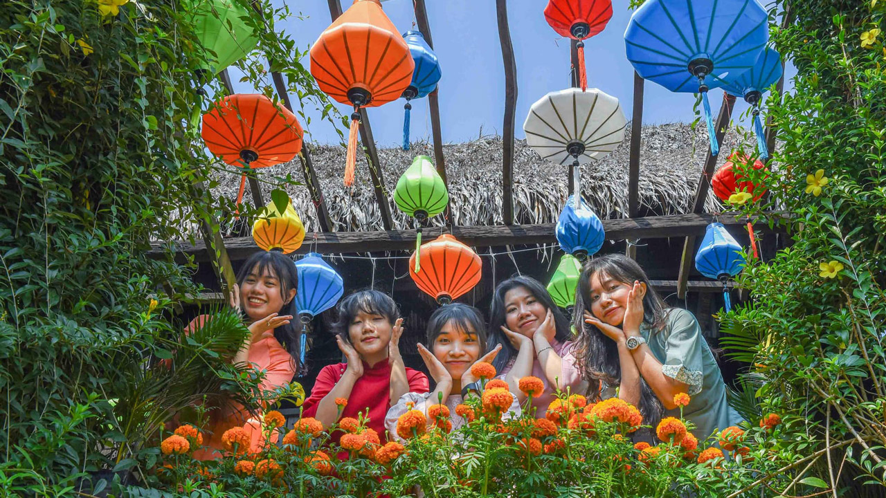 Tourists check in at the flower garden at Con En Lugar eco-tourism area in An Giang