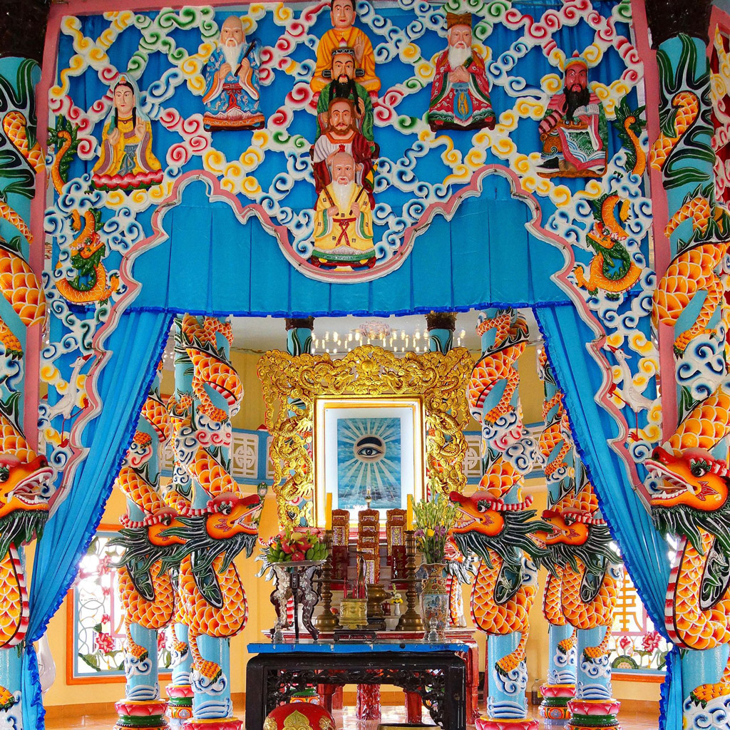 The interior space of the Cao Dai Temple is vibrant, featuring incredibly intricate carvings