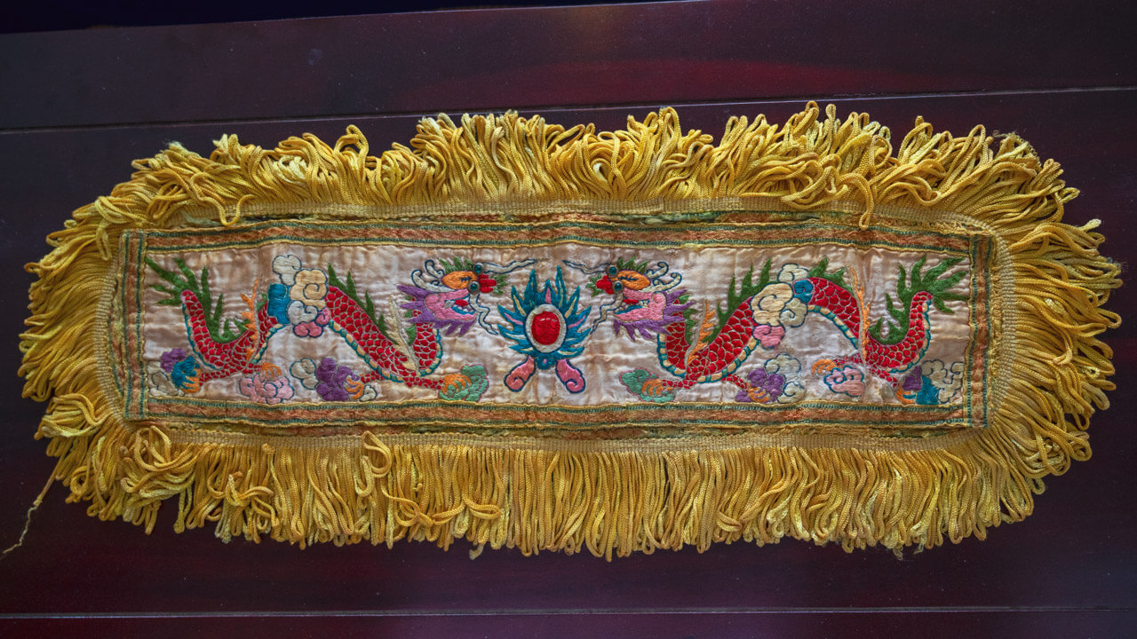 Golden dragon embroidery piece at Le Cong Ancestral House, a symbol of power and prosperity in Vietnamese culture