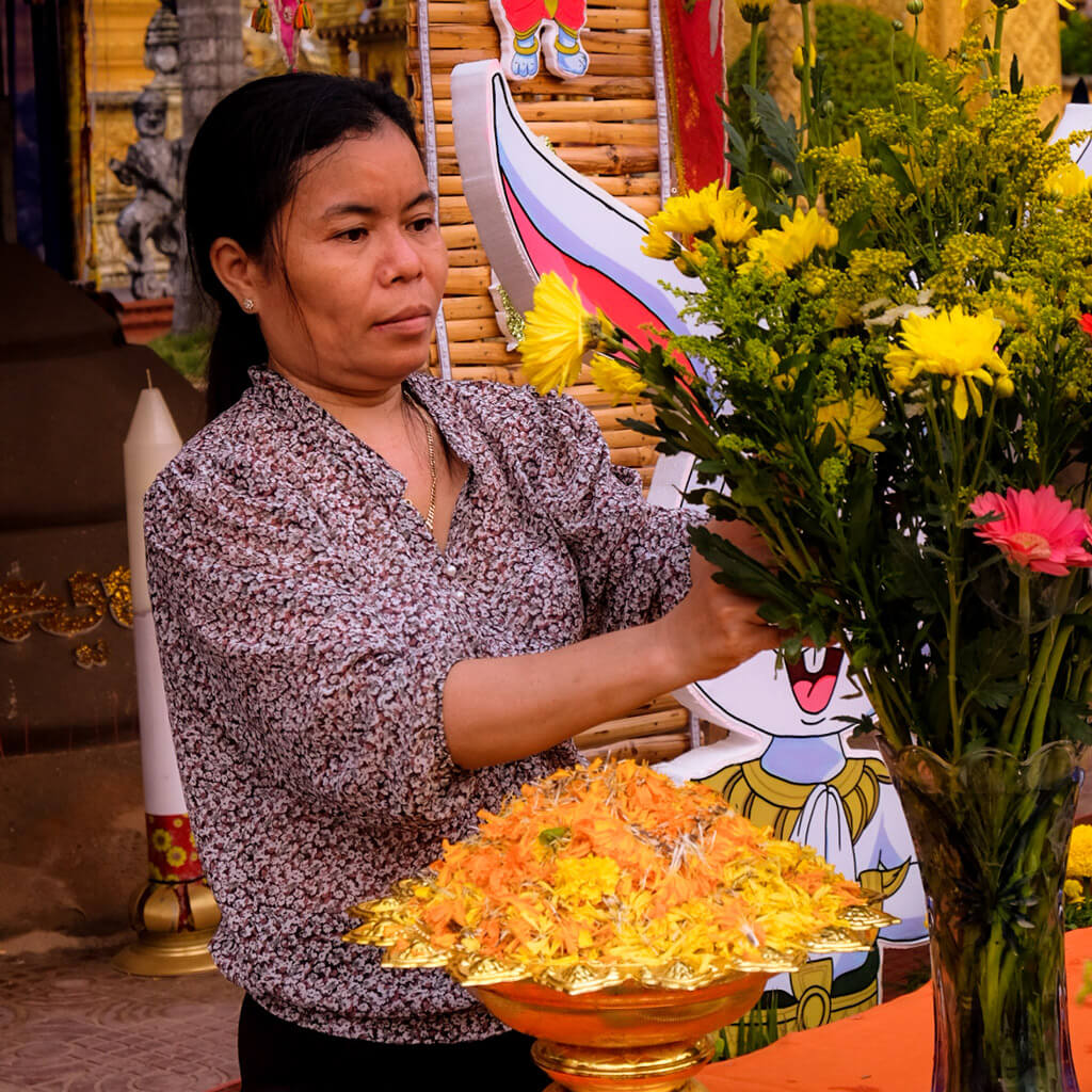 A woman arranging flowers for a Buddhist festival celebration in Vietnam