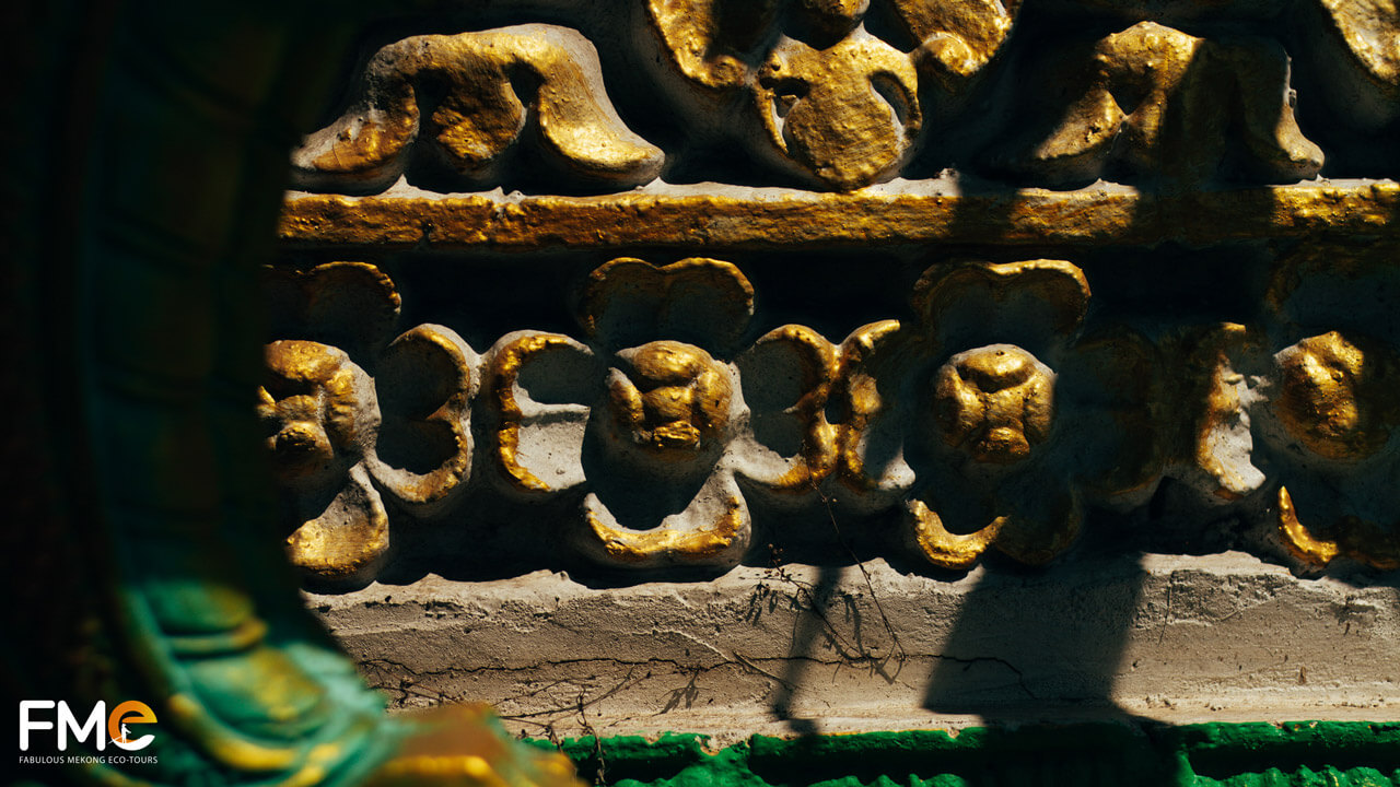 Intricately detailed golden floral patterns at Pitu Khôsa Răngsây Temple, reflecting Khmer traditional craftsmanship