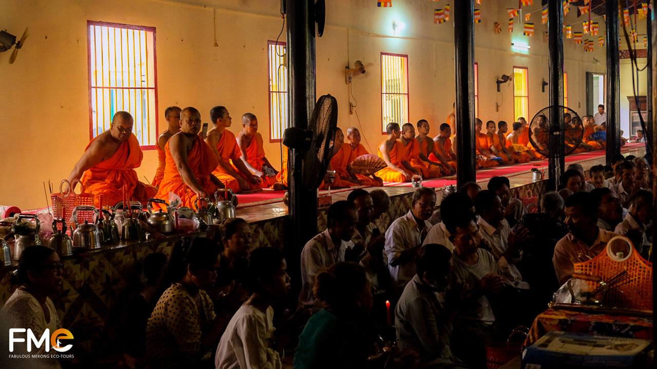 Monks praying during a Buddhist ceremony in Vietnam with the community in attendance