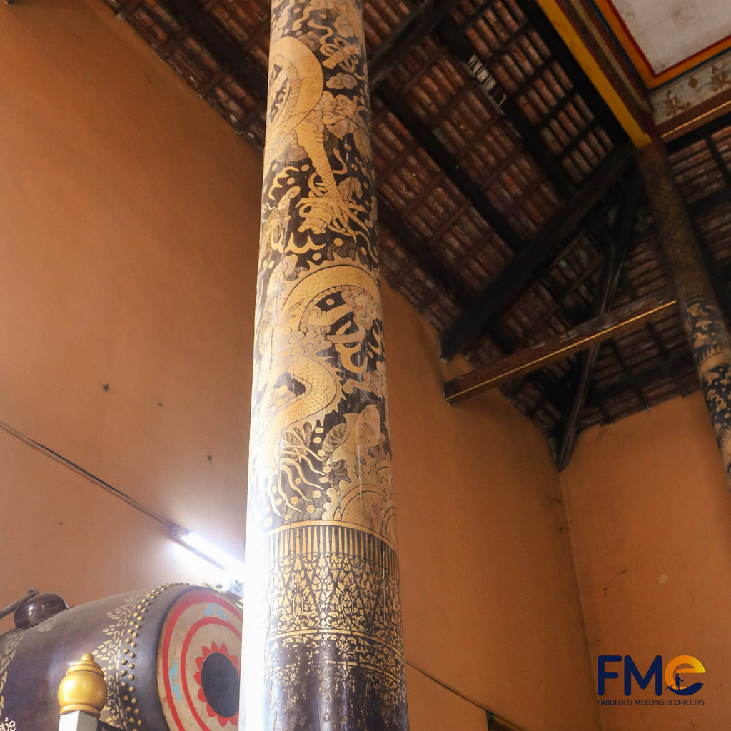 Intricate dragon carvings on a pillar at Kh'leang Pagoda in Soc Trang