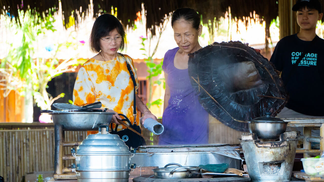 A hands-on experience at My Khanh Tourism Village where tourists learn the traditional art of making Vietnamese rice paper, known as banh trang