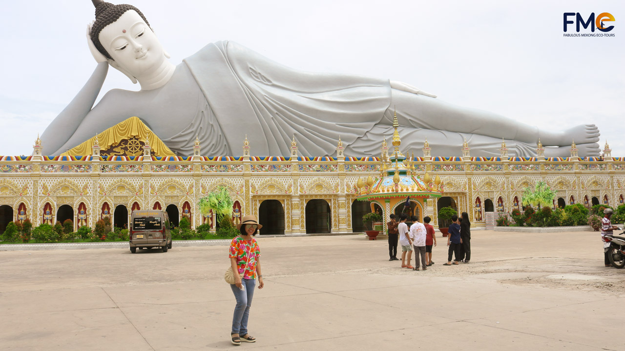 Majestic Reclining Buddha statue at Som Rong Pagoda in Soc Trang, showcasing intricate Khmer design