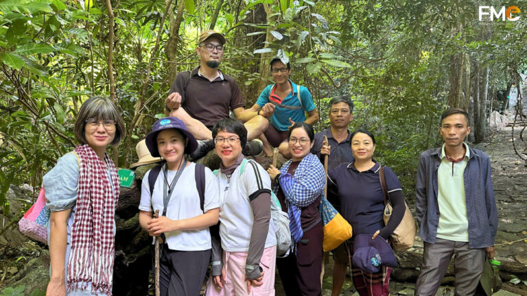 Visitors take a photo when participating in a hiking activity in Con Dao