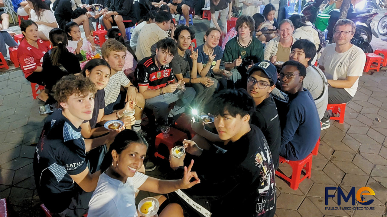 Group of international students enjoying traditional street food in Can Tho, Vietnam, during a cultural exchange program.