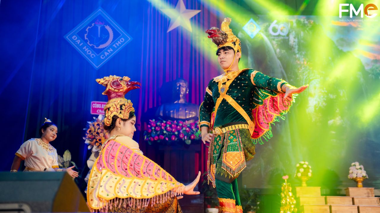 A group of Khmer female students in golden traditional costumes and headdresses performing a graceful dance at the 2026 Chôl Chnăm Thmây celebration.