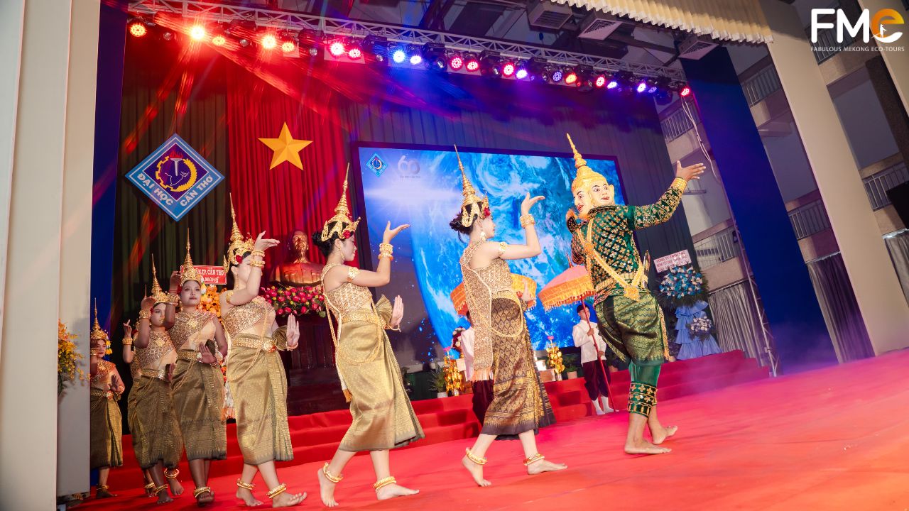Khmer students performing a traditional dance in golden costumes on a brightly lit stage at Can Tho University during the 2026 Chôl Chnăm Thmây festival.