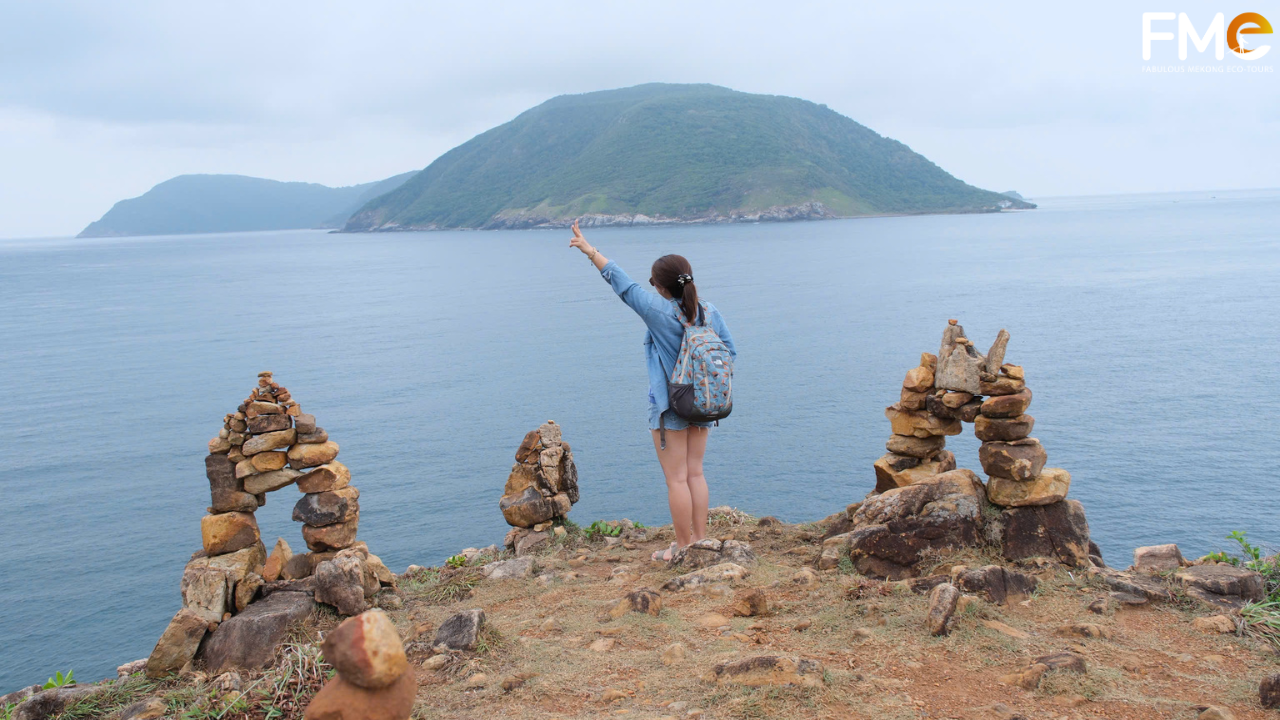 A solo traveler looking out at the majestic islands of Con Dao, embracing the peaceful and soulful connection with nature.